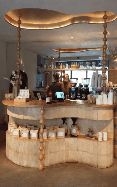 Barista pouring foam in a cappucino cup.